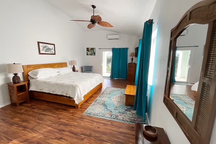 King sized bed in the master ensuite bedroom.. Hardwood frame and local art. The mattress is from Nest Bedding and is created in a US-based, certified organic ECO-FACTORY ™   with virgin steel coils, no polyurethane foams or synthetics.