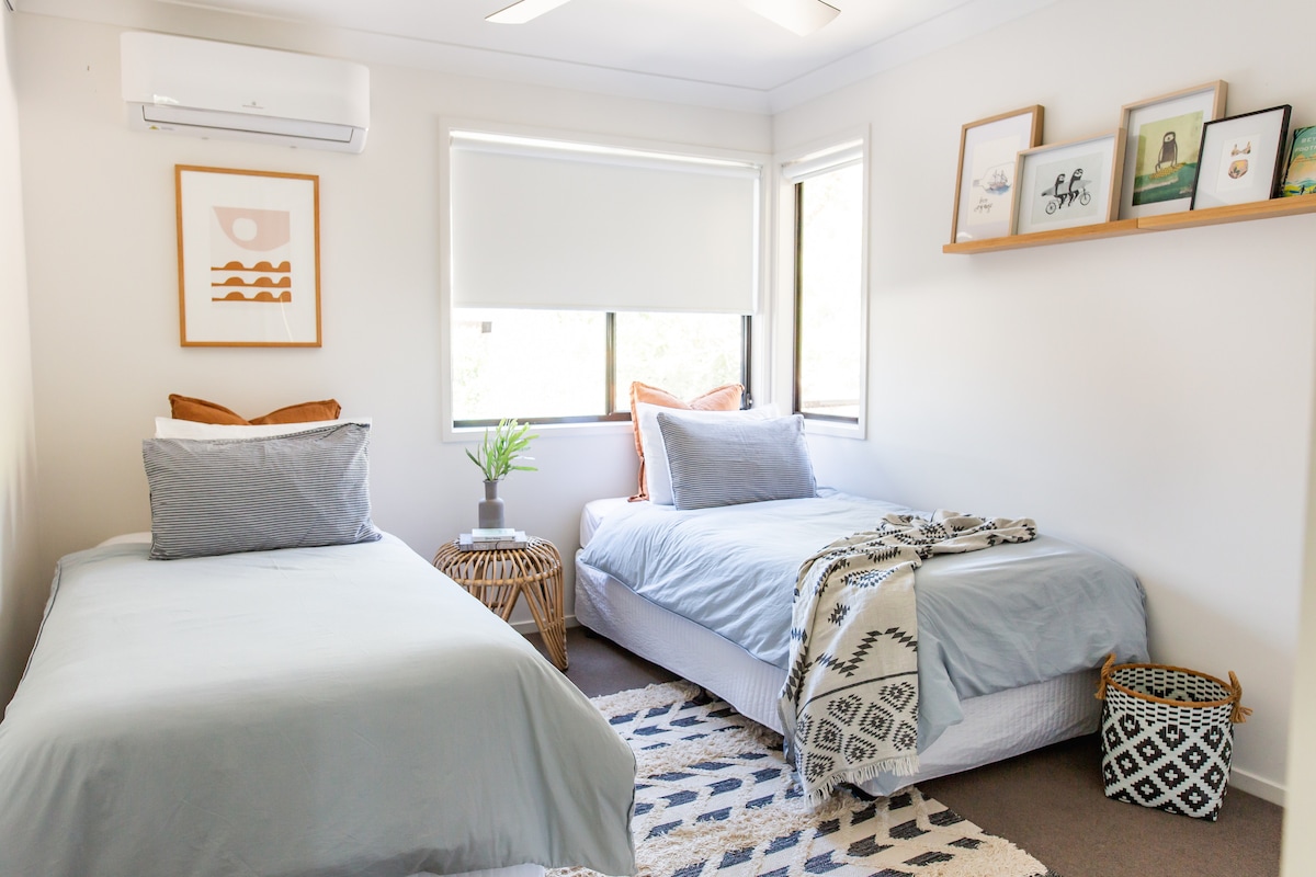 Twin bedroom with bush garden views