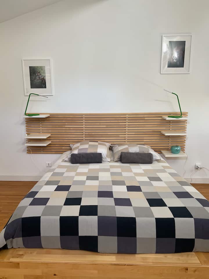 Queen size bed of the upper bedroom