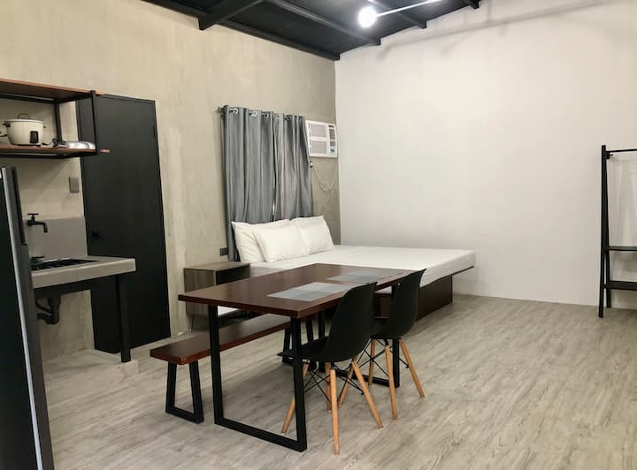 This is Studio Apartment B. 

It features a king-size bed, private bathroom with basic toiletries, kitchen with simple cooking utensils and dinnerware, plus a dining area. 

This unit was refurbished on April 2022.