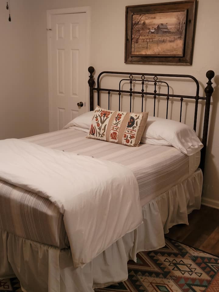 Antique style queen size bed in the master bedroom.