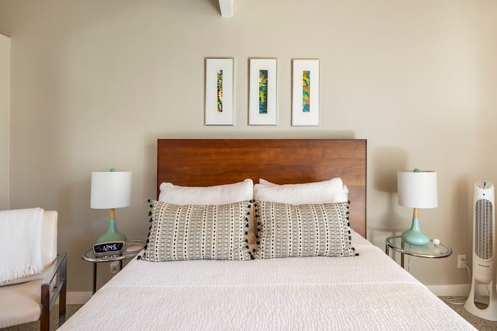 The larger guest room offers a cozy place to sleep and access to the private patio.