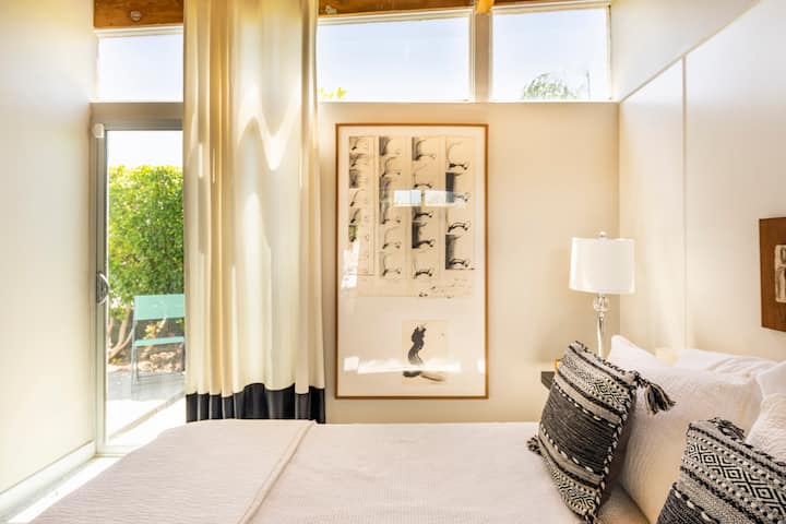The middle guest room offers great style and access to a private patio.
