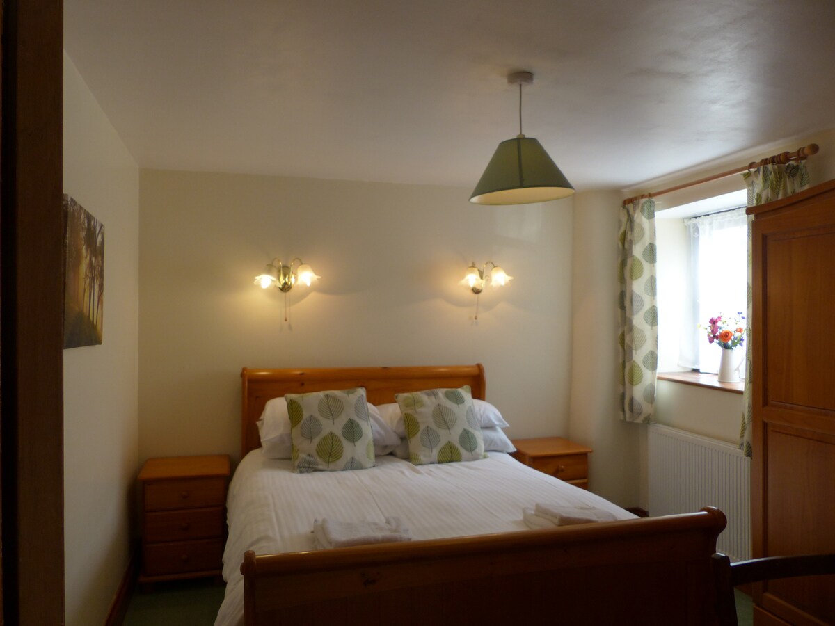 ห้องนอนเตียงใหญ่พร้อมตู้เสื้อผ้าโต๊ะเครื่องแป้งและกระจกขนาดใหญ่