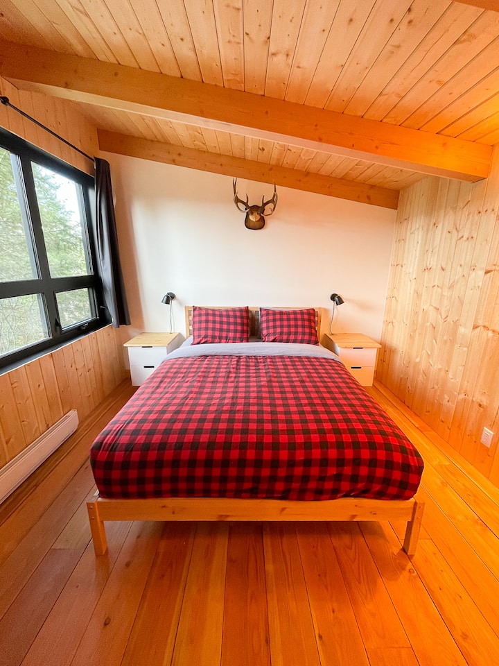 Bedroom in the bunkhouse with a queen bed and an incredible view!