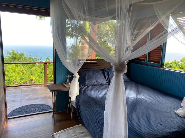 Main floor bedroom - opens onto the deck with views of the sea and the "bush"