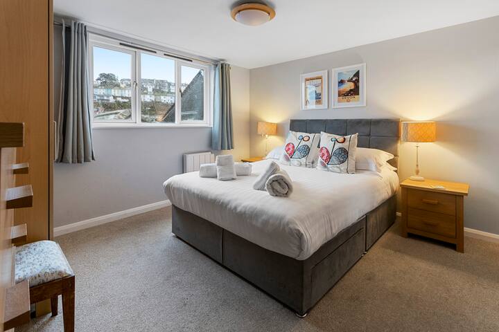 Bilik tidur utama dengan en-suite di tingkat atas, termasuk katil kelamin dan cadar mewah dan bantal untuk tidur malam yang nyenyak