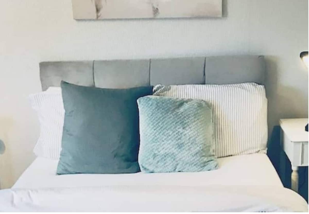 Large bedroom with  fast broadband laptop workstation. -  wooden bureau  faux leather swivel  chair mini fridge TV - Netflix /Alexa chest of draws and wardrobe. Next door is your own private bathroom.