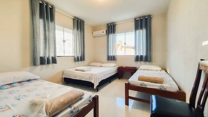 Bedroom with 1 double bed, 2 single beds and air conditioning.