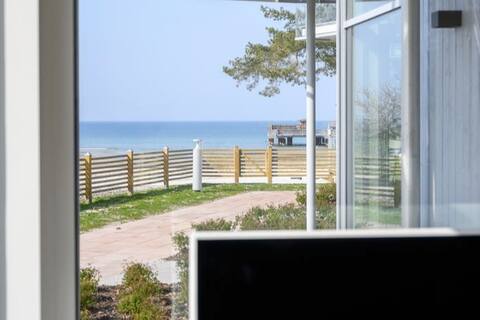 Apartment with sea view and pool by the beach