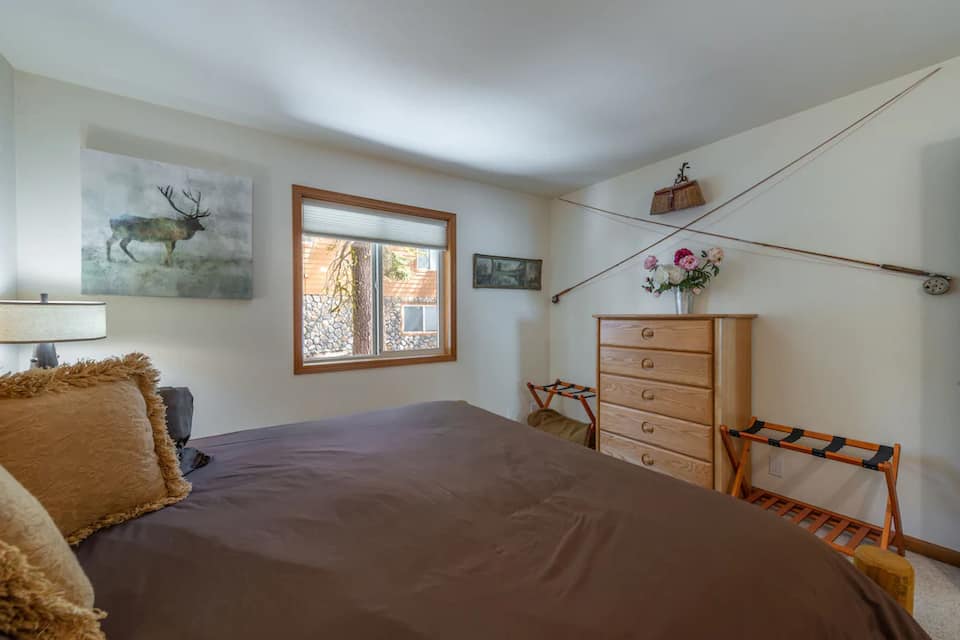 Main floor king bedroom with bureau and closet