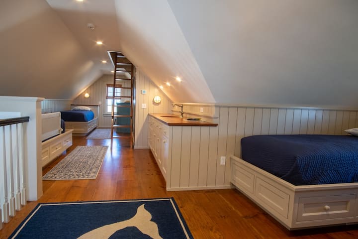 The third floor loft sleeping area features 4 full size twin built-in day beds, a wet bar with beverage drawers, and the access to the main house roof walk.