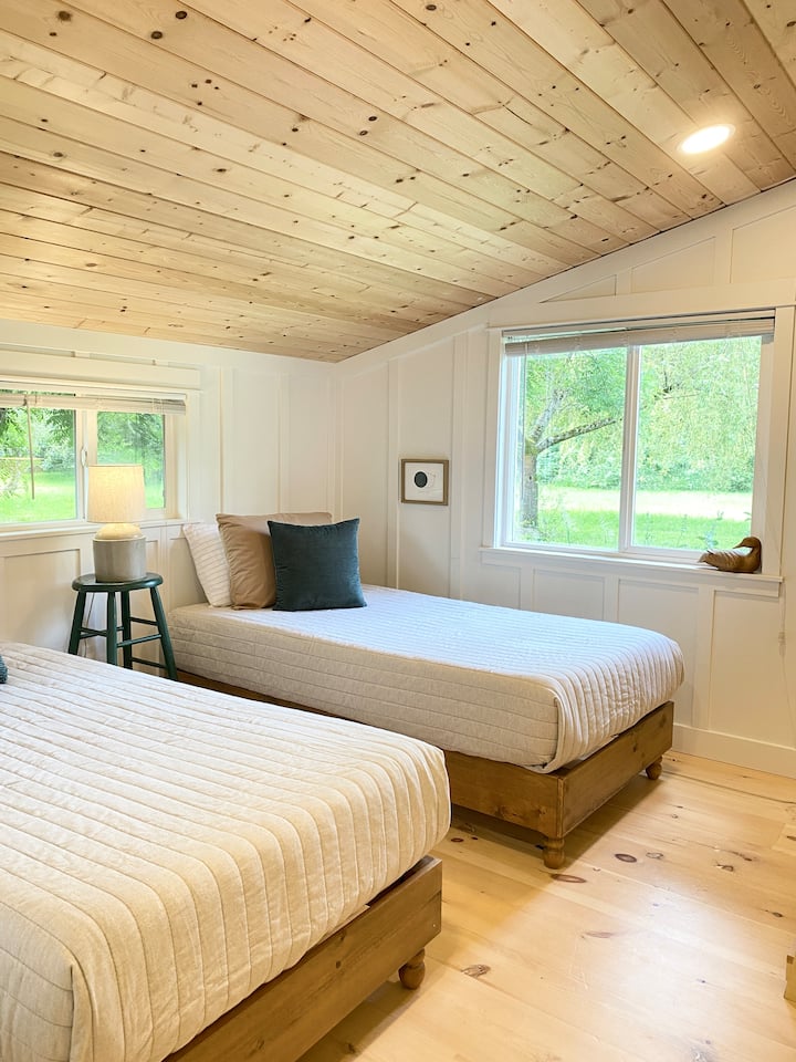 Twin beds with brand new Tuft & Needle Original mattresses invite relaxation for adults and children alike. 