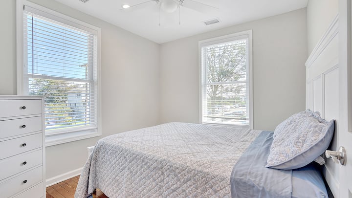This 2nd floor bedroom features a queen bed, dresser and closet. The two windows allow tons of light into the room.