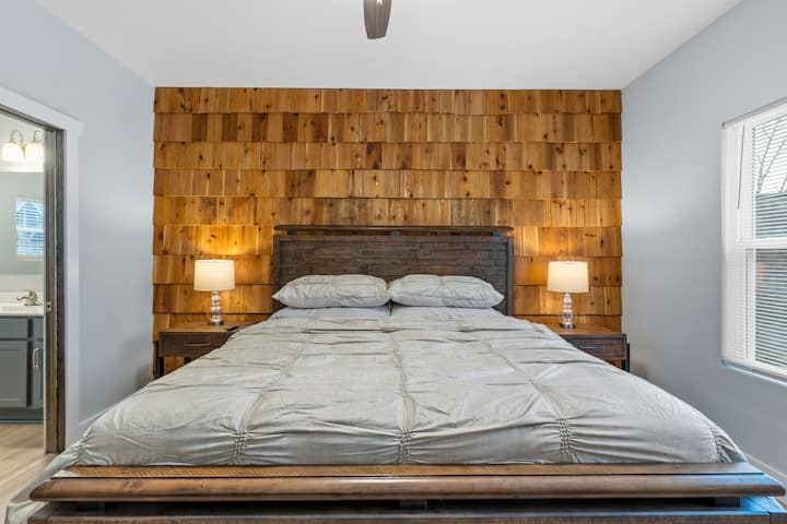 The main level has a bedroom suite with a king size bed and a smart TV.