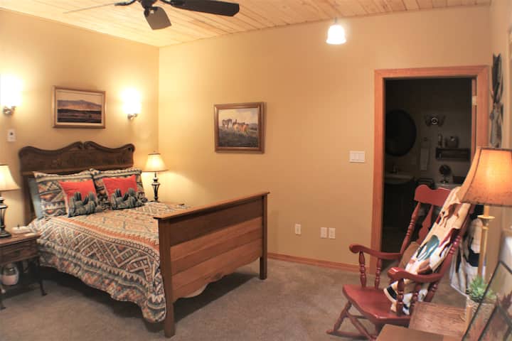 This downstairs room, “Mustang Alley” features a queen size bed, window with a view and an en suite bathroom.  This is our most “accessible” room with a shower big enough for wheelchair access.