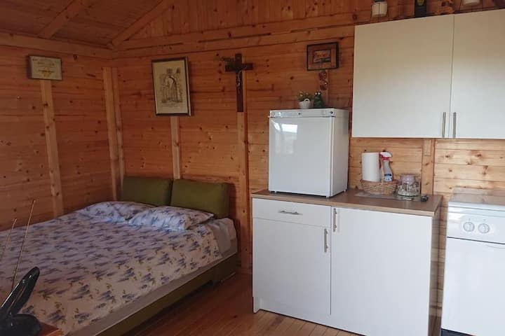 Interior (bed 140x200 cm, small kitchen with small fridge and stove)