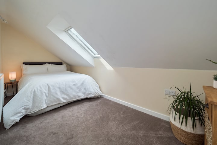 Third bedroom with small double bed and wardrobe. Views of the fields and Moorlands from the window. Natural light brightens the room.