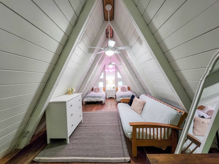 Awesome loft space with our signature neon sign, two twin beds and futon