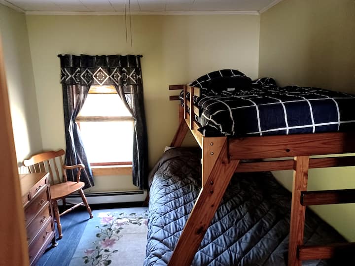 Პატარა საძინებელი ტყუპი სრული მძიმე მორიგეობით. Კარადა გამოსაწევი მაგიდით ორი სკამითა და ჭერის ვენტილატორით.