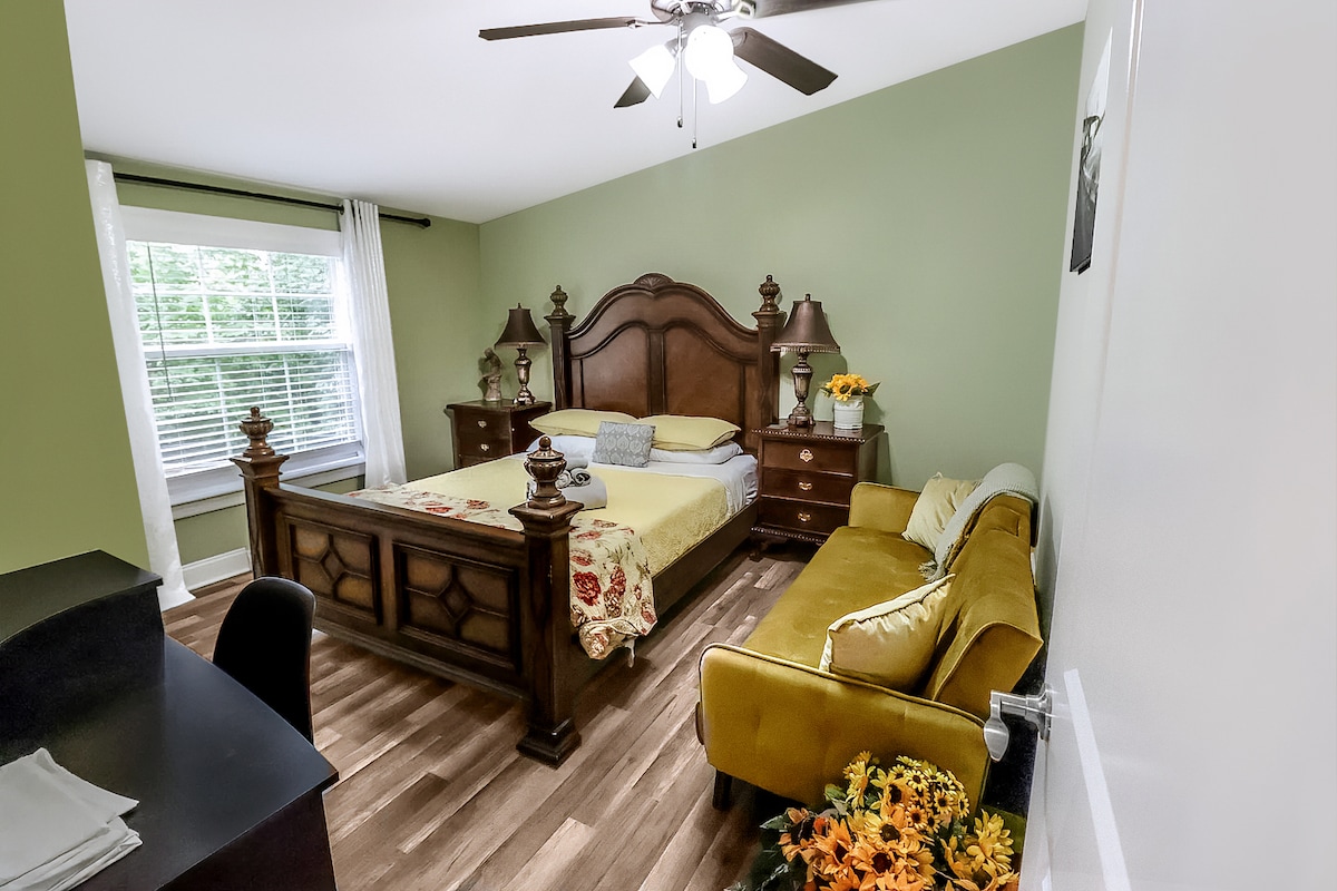 Bedroom three is filled with a queen bed with a folding sofa bed and a workspace