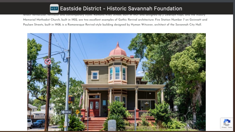A historic structure is framed by a vibrant green lawn, featuring intricate Gothic Revival architecture. The building showcases a distinctive tower topped with a decorative feature. Surrounding sidewalks are lined with trees, and street signs contribute to the lively urban environment.