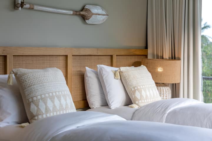 Bedroom 5, located in the main building has space for up to three people. Can be configured as a king + single or as three single beds. Balcony to two sides, with an outside walkway connecting to bedroom 6. 