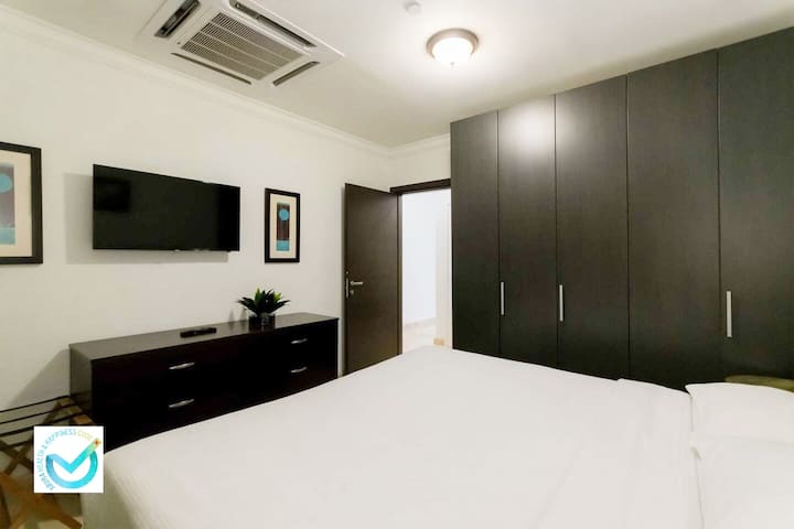 Master Bedroom with loads of wardrobe space along with a flat screen TV.Rest easy in our serene king bedroom ️ in sunny Palm Beach, Aruba .Soft linens, cool A/C❄️, and island charm await just minutes from the sea .Your dream stay starts here!