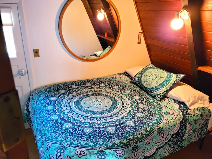 This is the queen bedroom on the main level with it's own door to a small deck that views the back yard.