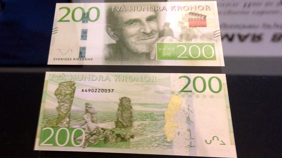 A Swedish 200 kronor banknote is displayed, showing the front and back designs. The front features iconic cultural symbols, and the back depicts the landscape of Fårö, including the distinctive rauk formations, contributing to the region's natural beauty.