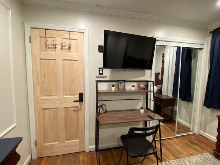 Room 1 queen size bed,  TV desk and mini fridge