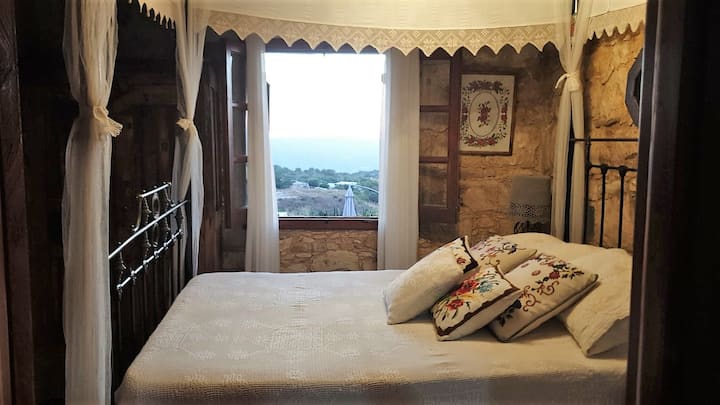 Beautiful romantic traditional over 100 years old 4 poster bed with handmade accessories. And a window view to die for!
