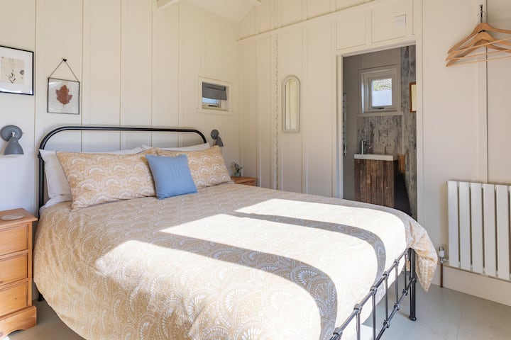 A comfy king sized bed.  Large picture windows with a view across the garden to the 11th century Church next door. It’s open every day to visitors, a very pretty little Church. 

Relax & recharge right here… 