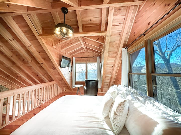 King bed in upstairs master bedroom in open loft