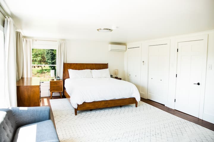 Master Suite: unbelievably romantic, the master bedroom has it all: midcentury California king bed, one-of-a-kind fieldstone fireplace, and the best view on the property.