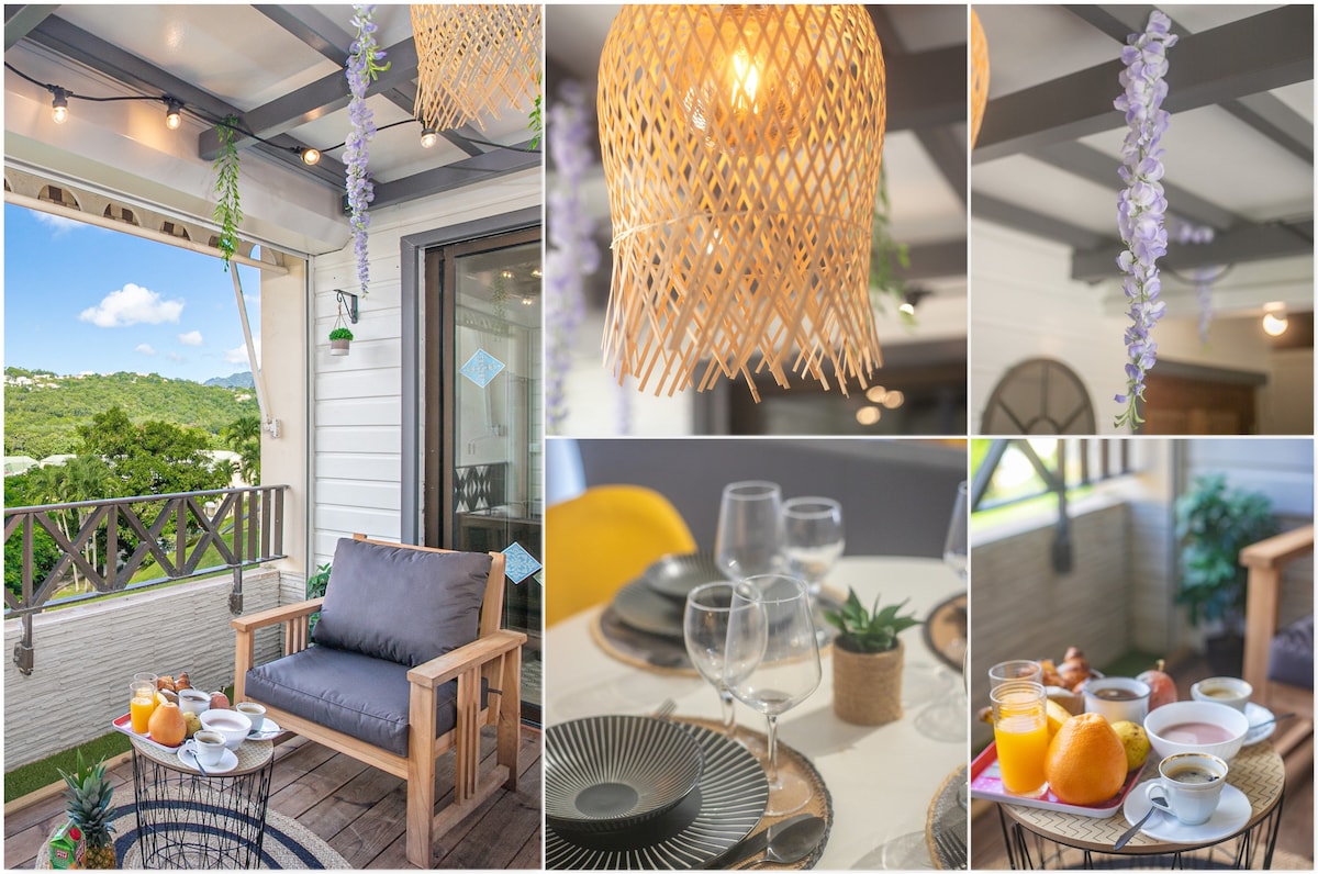 The terrace is furnished with a comfortable seating area and a table set for breakfast, showcasing an assortment of food and drinks. Warm light fixtures hang overhead, while greenery enhances the outdoor space and offers views of the surrounding landscape.