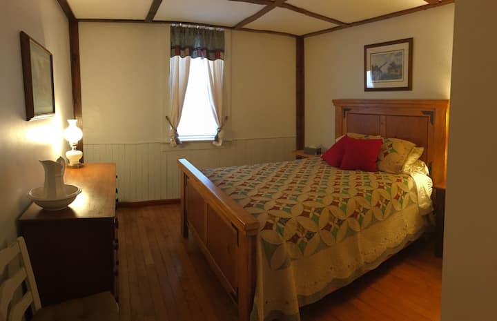 Largest bedroom with a queen-size bed and closet.  The photo was taken with a pano scan, so it caused a bend in the picture.