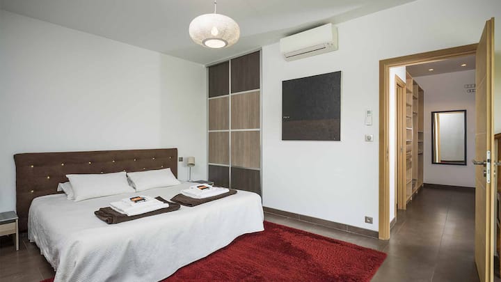 La Master Bedroom au rez de chaussée avec son grand lit 2m x 2m. Accès direct sur la terrasse 