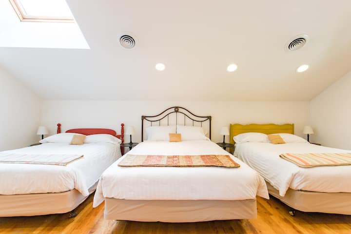 Dormitory Bedroom with a Queen Bed and two Double Beds with a Shared Bathroom.  Located on the second floor and sleeps 6.