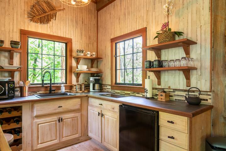 A beautiful, fully stocked kitchen - even in a treehouse! The ambrosia kitchen cabinets were hand-crafted in Jeff’s woodworking shop. Note: Fridge is under-counter with an ice tray freezer.
Credit: Dickersonarts.com