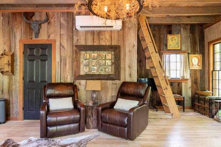 Leather recliners offer the ultimate in treehouse comfort. The art pieces — original, hand-painted blocks from Stellenbosch, South Africa — each tell a story of their own. The authentic barn wood is over 100 years old.