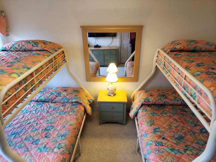Bunk Room with 2 double beds (bottom), 2 twin beds (top), 50" smart HDTV and DVD.  Guests use the Hall Full Bathroom.