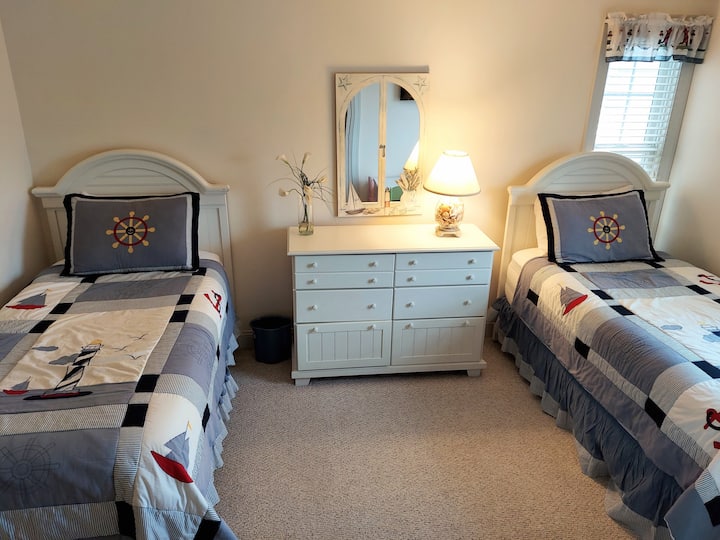 Twin BR with 2 twin beds, 40" HTDV with DVD and kid's table.  Guests use the Hall Full Bathroom.