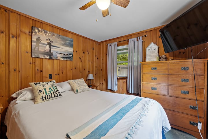 Main floor bedroom with double bed and smart tv.