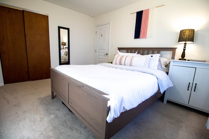 Queen Size bed with cabinet for your belongings, bedside lamp and charging station. 
