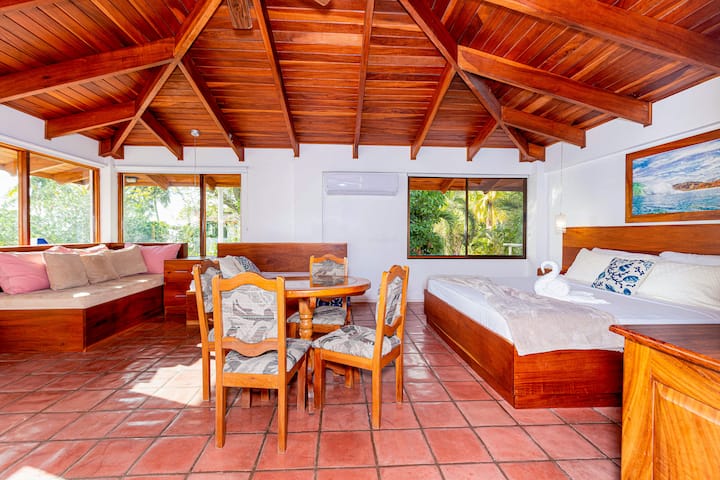 This spacious upper-floor bedroom features two queen beds and two twin beds, comfortably accommodating up to six guests. Enjoy the convenience of an ensuite bathroom for added privacy and comfort.