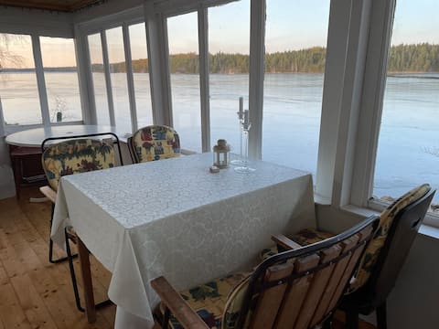 Peninsula with very simple house next to the water.