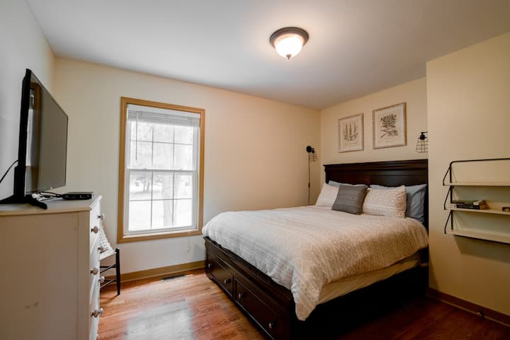 Bedroom #1 features a queen bed with under bed storage, side shelf and  reading lamps.