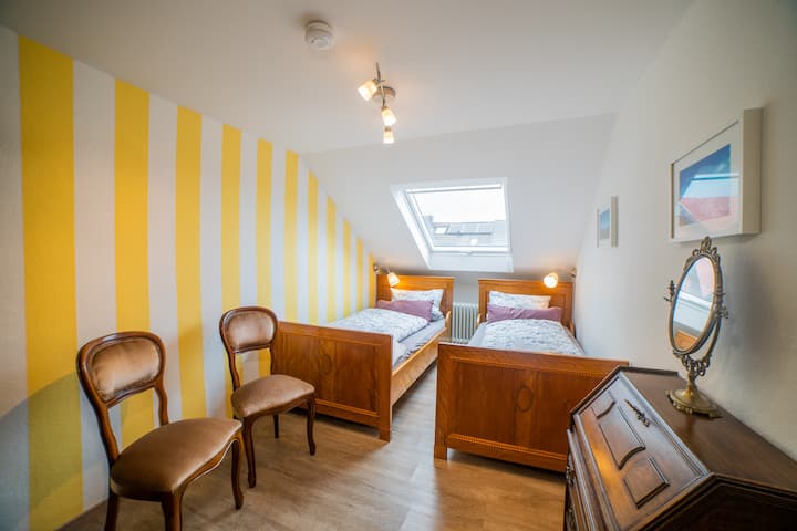 Two cozy wooden beds in the attic floor