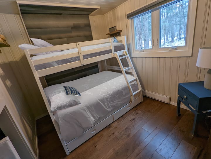 Downstairs Bedroom with single over double bunk. PLEASE NOTE: bed linens are not included in the stay; just shown here for staging purposes. Please see our listing info for more details :)